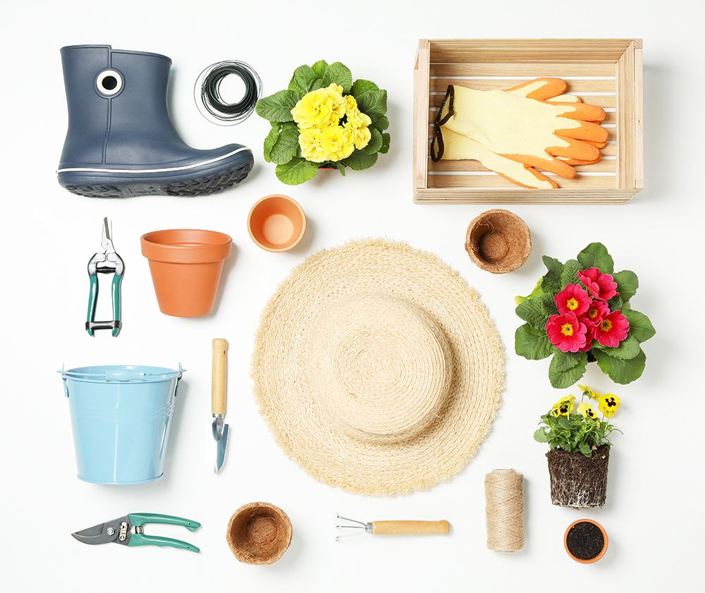 Composition with gardening tools and accessories on white backgr